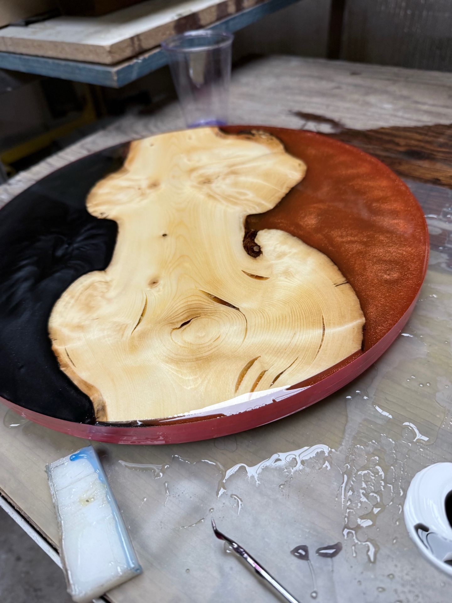 Round epoxy art piece with live-edge wood slab center